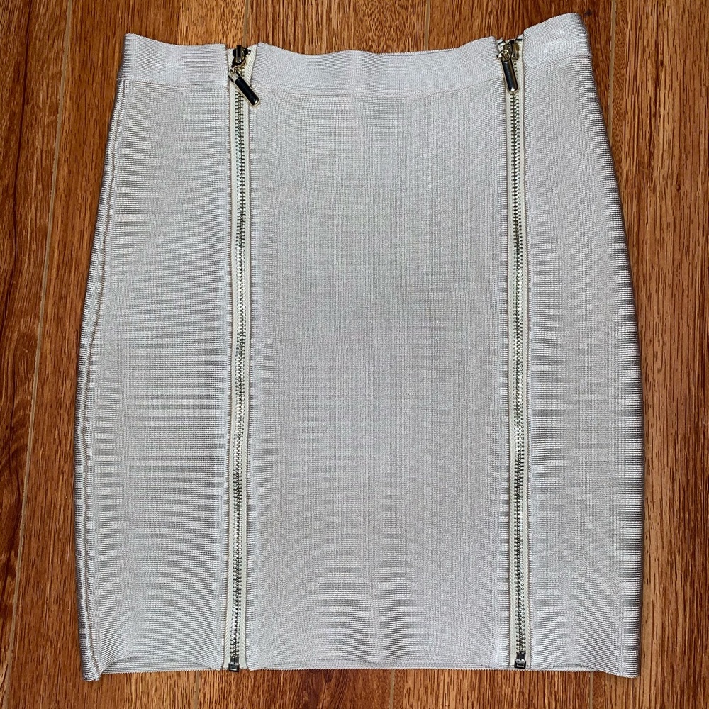 Bebe mini tan skirt with gold zippers size Small